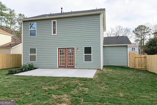 rear view of house featuring a yard, a fenced backyard, french doors, and a patio