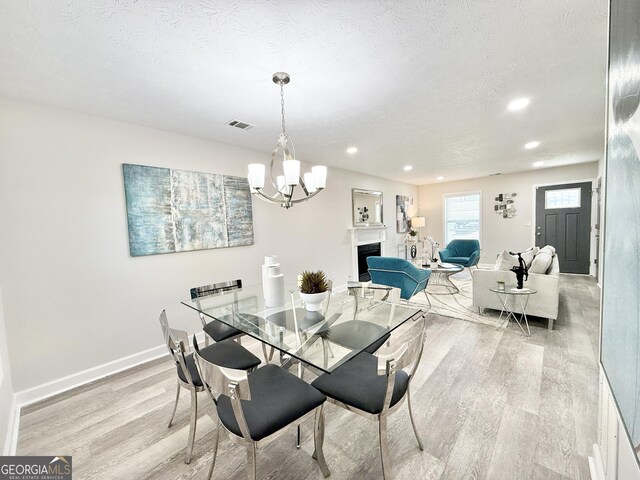 kitchen with stainless steel appliances, gray cabinets, light countertops, a sink, and ventilation hood