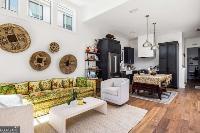 living area with visible vents and light wood finished floors