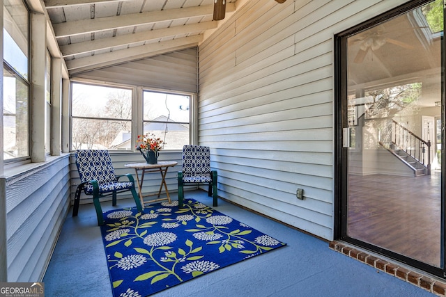 sunroom with lofted ceiling with beams