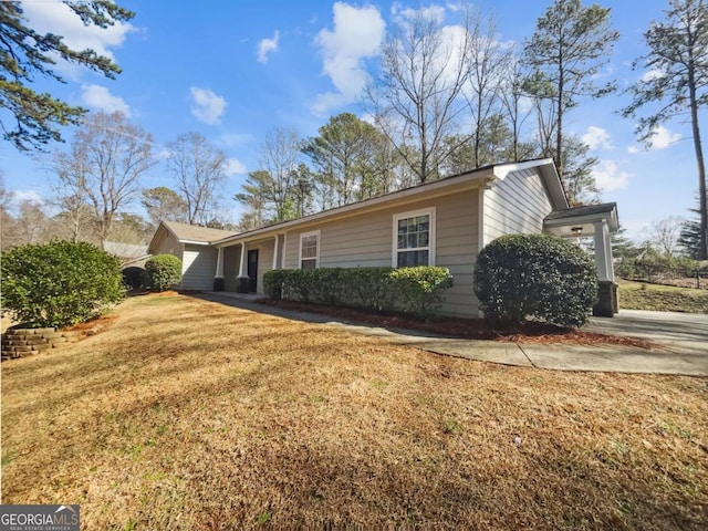 view of side of property featuring a yard