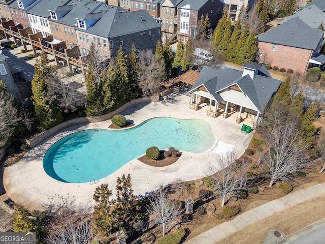 community pool featuring a patio area and a residential view