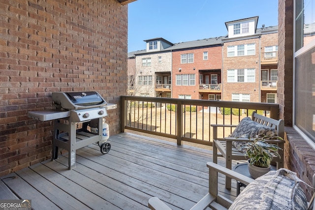 wooden deck with a grill