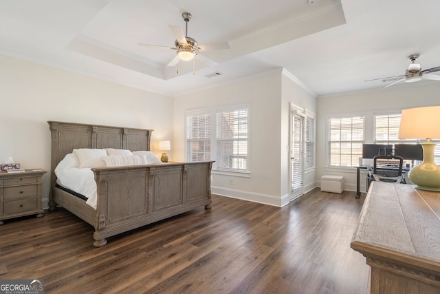 bedroom with baseboards, visible vents, a raised ceiling, and dark wood finished floors