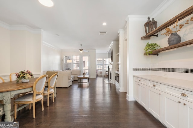 dining space featuring dark wood-style flooring, recessed lighting, visible vents, and crown molding