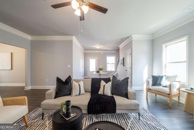 living room featuring visible vents, ornamental molding, ceiling fan, wood finished floors, and baseboards