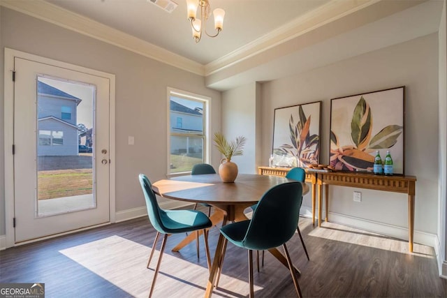 dining area featuring crown molding, dark wood finished floors, visible vents, a chandelier, and baseboards