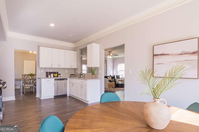 kitchen with crown molding, decorative backsplash, white cabinets, and stainless steel dishwasher