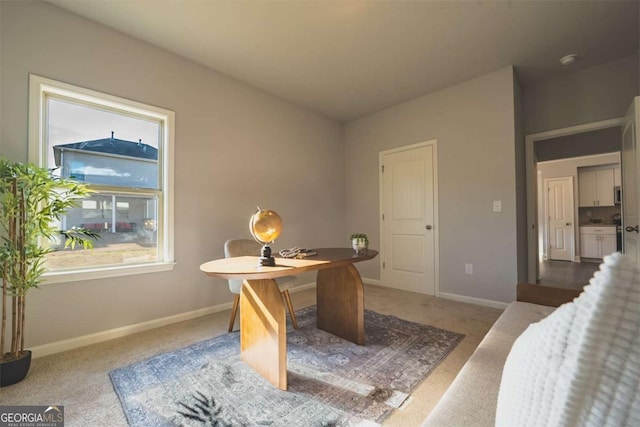 carpeted office featuring plenty of natural light and baseboards