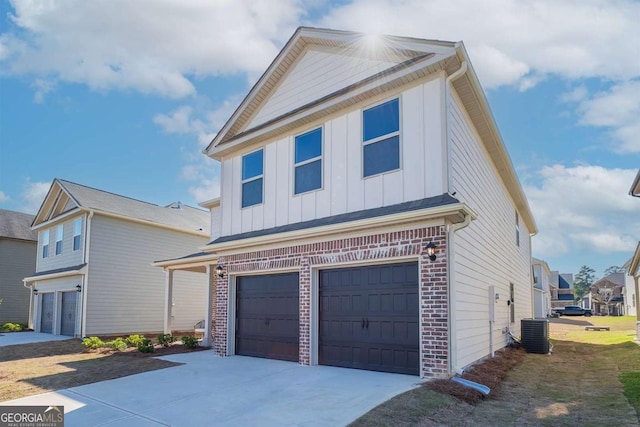 view of front of house featuring driveway, an attached garage, cooling unit, board and batten siding, and brick siding