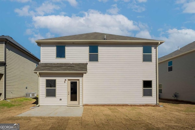 back of property featuring central air condition unit, a patio area, a lawn, and roof with shingles