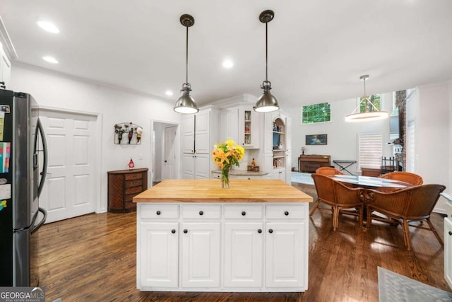 kitchen featuring glass insert cabinets, freestanding refrigerator, and white cabinets