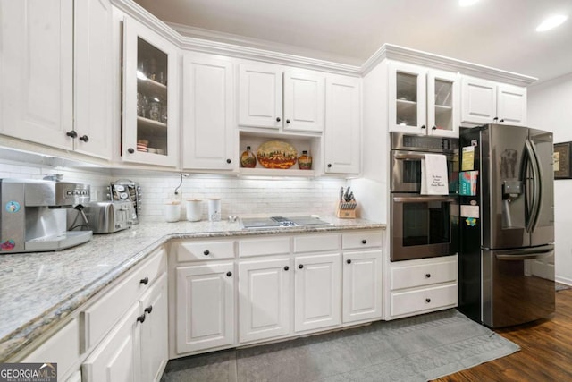 kitchen featuring stainless steel appliances, glass insert cabinets, and white cabinetry