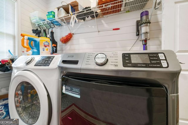 washroom featuring laundry area and washer and clothes dryer