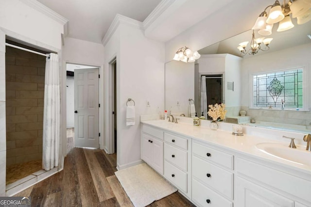 full bath featuring a notable chandelier, double vanity, a sink, a shower stall, and wood finished floors