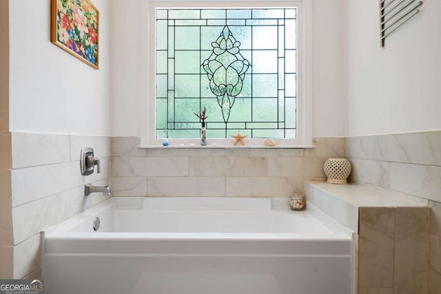 full bathroom with tile walls and a bath