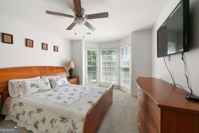 bedroom featuring ceiling fan, visible vents, and light colored carpet