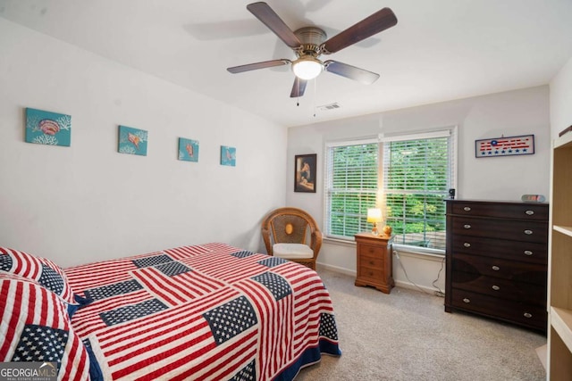 bedroom with baseboards, visible vents, a ceiling fan, and light colored carpet