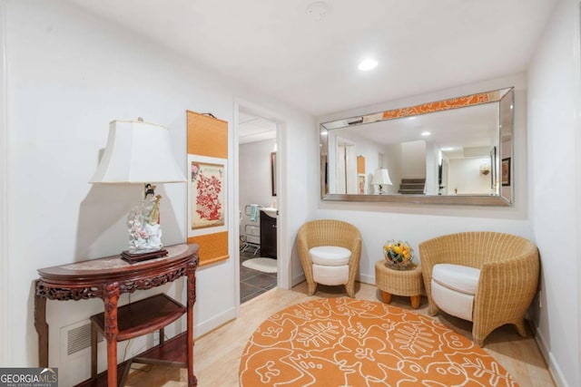 sitting room featuring recessed lighting, stairway, baseboards, and wood finished floors