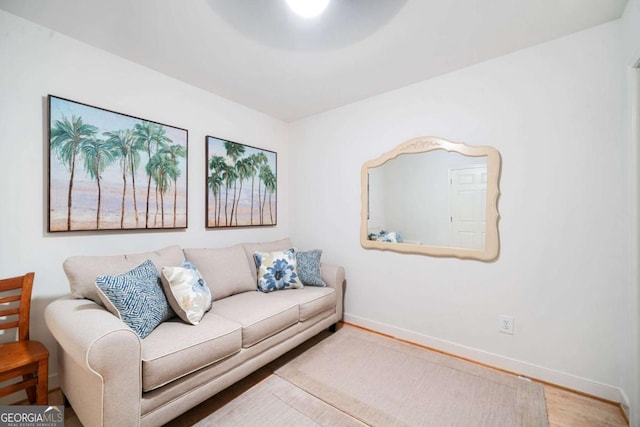 living area featuring baseboards and wood finished floors