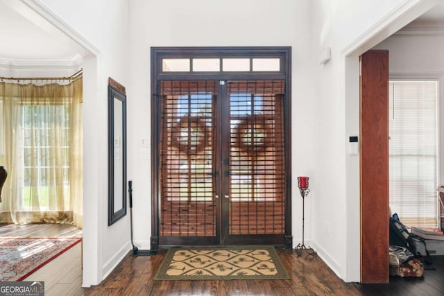 foyer with baseboards, french doors, dark wood-style flooring, and crown molding