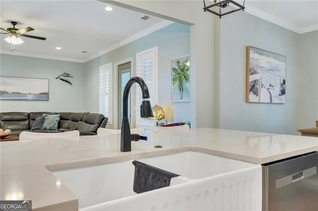 kitchen featuring a sink, visible vents, light countertops, ornamental molding, and dishwasher