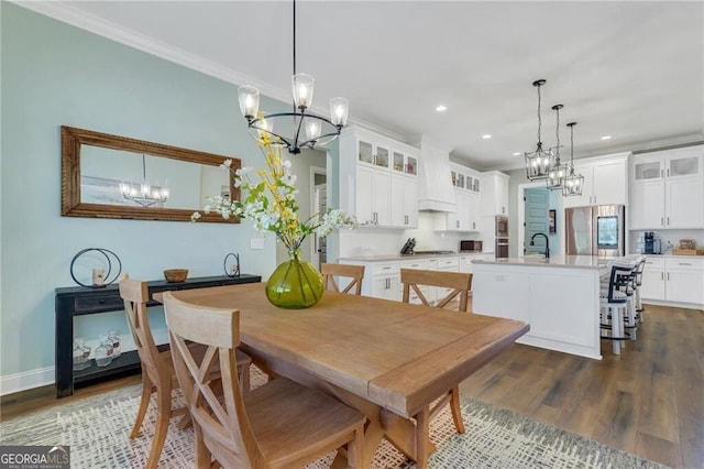 dining area featuring ornamental molding, dark wood-type flooring, recessed lighting, and a notable chandelier