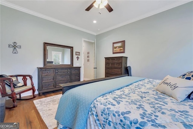 bedroom featuring a ceiling fan, ornamental molding, wood finished floors, and recessed lighting