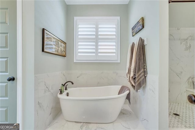 bathroom with a freestanding bath, marble finish floor, wainscoting, and a marble finish shower