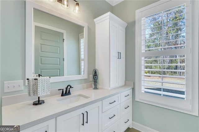 bathroom featuring baseboards and vanity