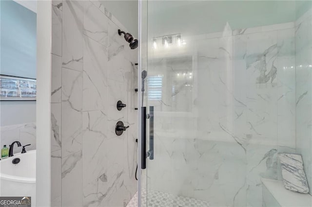 full bathroom with a freestanding tub and a marble finish shower