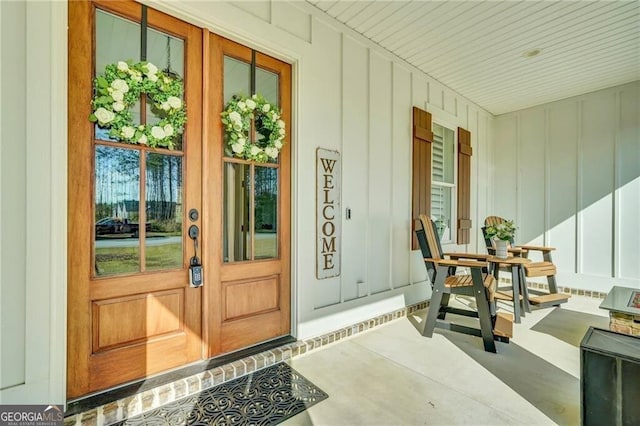 view of exterior entry with board and batten siding