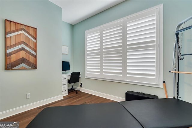 office with dark wood finished floors and baseboards