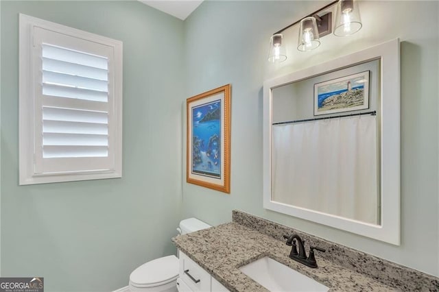 bathroom with toilet and vanity