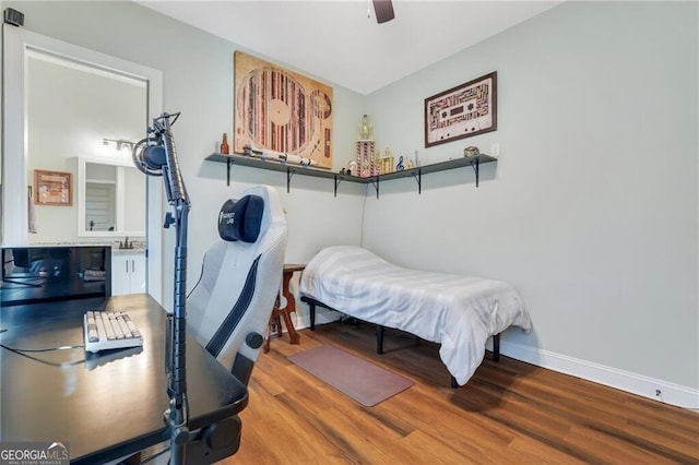 bedroom featuring a ceiling fan, wood finished floors, connected bathroom, and baseboards