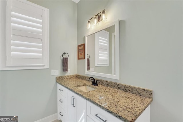 bathroom with vanity and baseboards