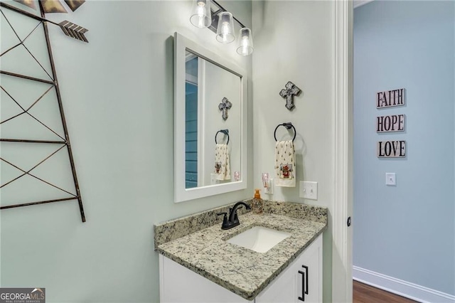 bathroom with vanity and baseboards