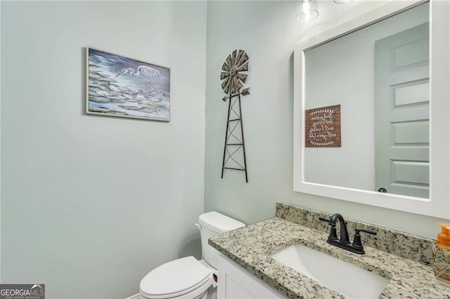 bathroom featuring toilet and vanity