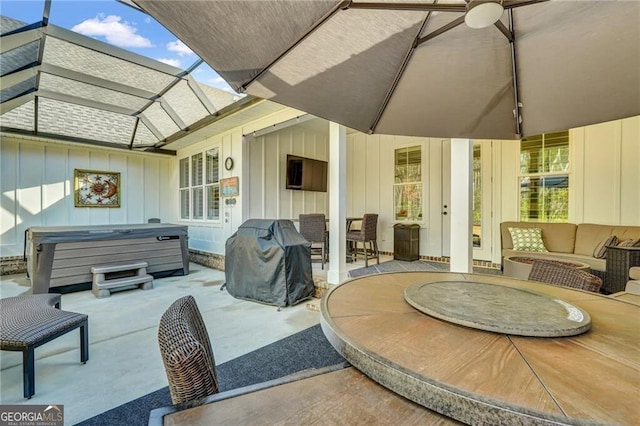 view of patio featuring an outdoor hangout area, outdoor dining space, a hot tub, and grilling area