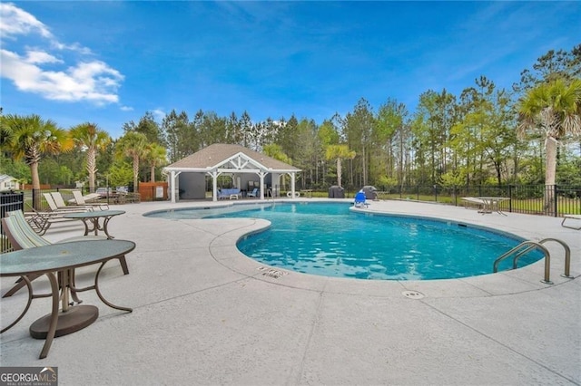 pool with fence and a patio