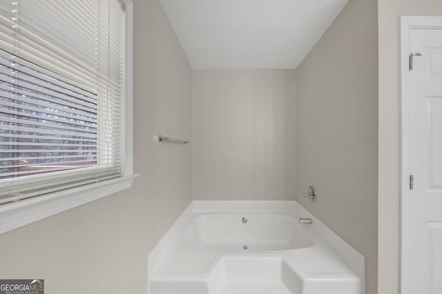 bathroom with a garden tub