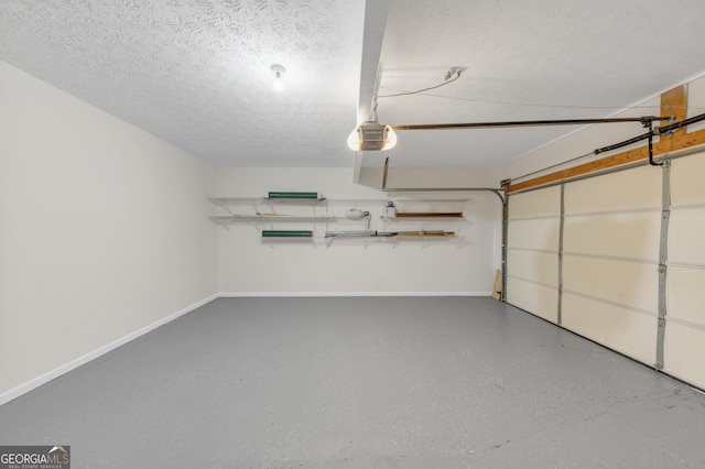 garage featuring a garage door opener and baseboards