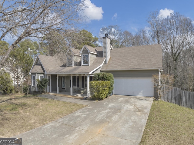 new england style home with covered porch, a front yard, fence, and a garage