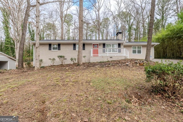 ranch-style home featuring covered porch, brick siding, crawl space, and a chimney