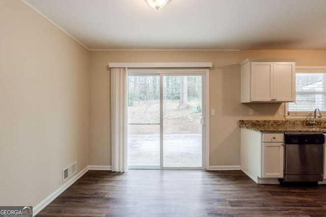 kitchen with dark stone counters, white cabinetry, dark wood finished floors, and stainless steel dishwasher