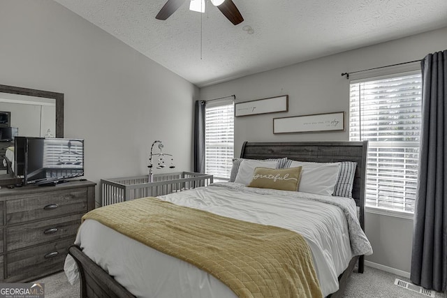 bedroom featuring light carpet, multiple windows, visible vents, and lofted ceiling