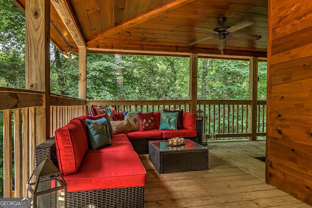 wooden terrace with a ceiling fan and an outdoor hangout area