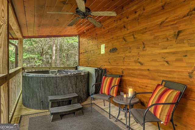 view of patio / terrace with ceiling fan and a hot tub