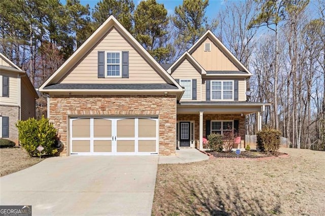 traditional-style home with board and batten siding, concrete driveway, stone siding, and a garage