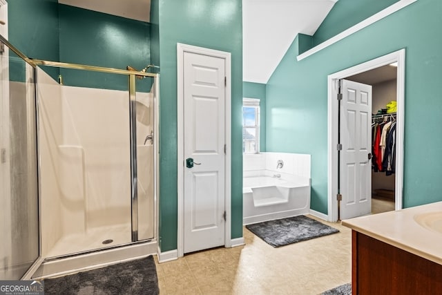 bathroom with vanity, a shower stall, a bath, and baseboards